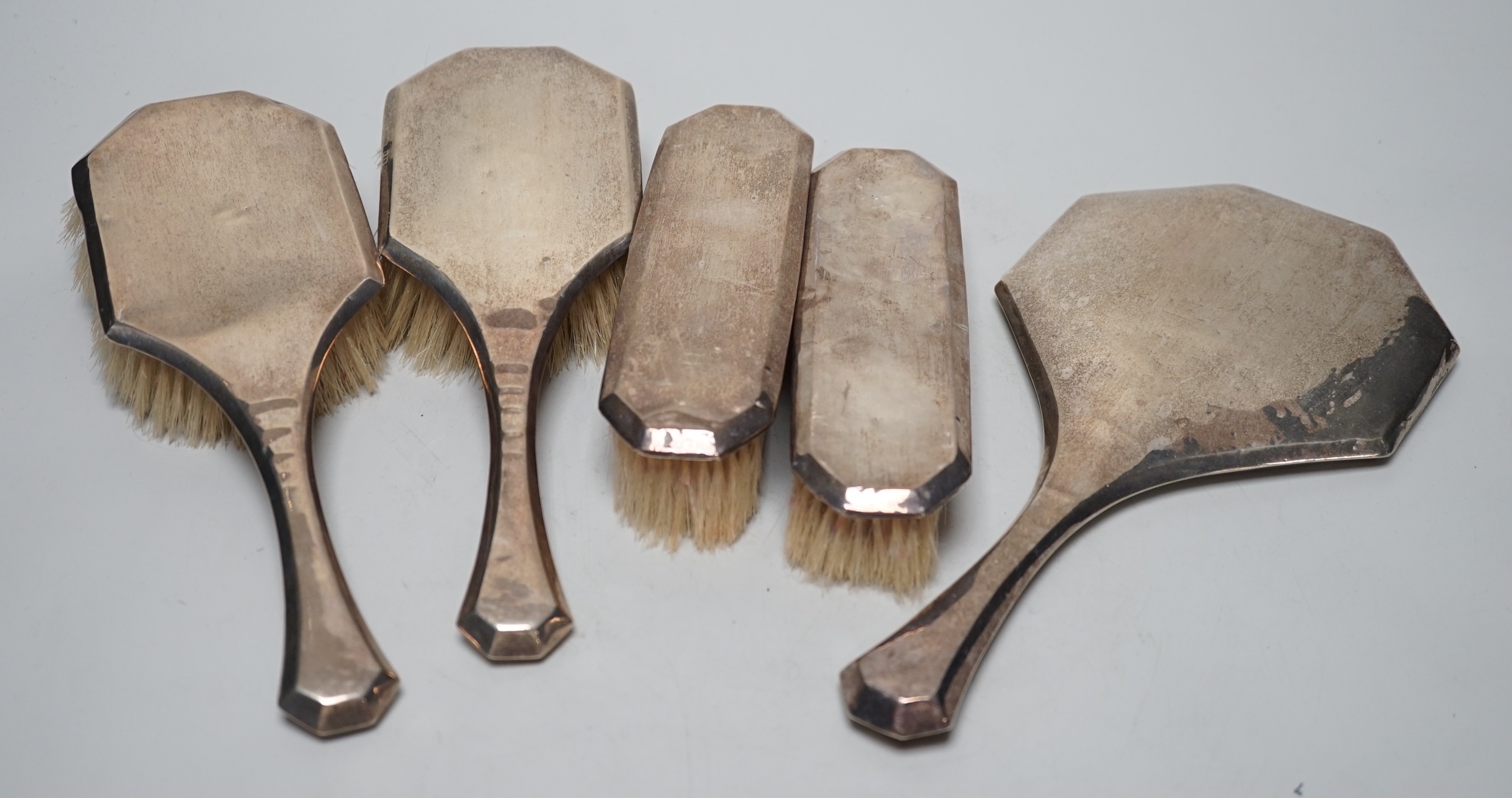 A 1920's silver mounted five piece mirror and brush set.